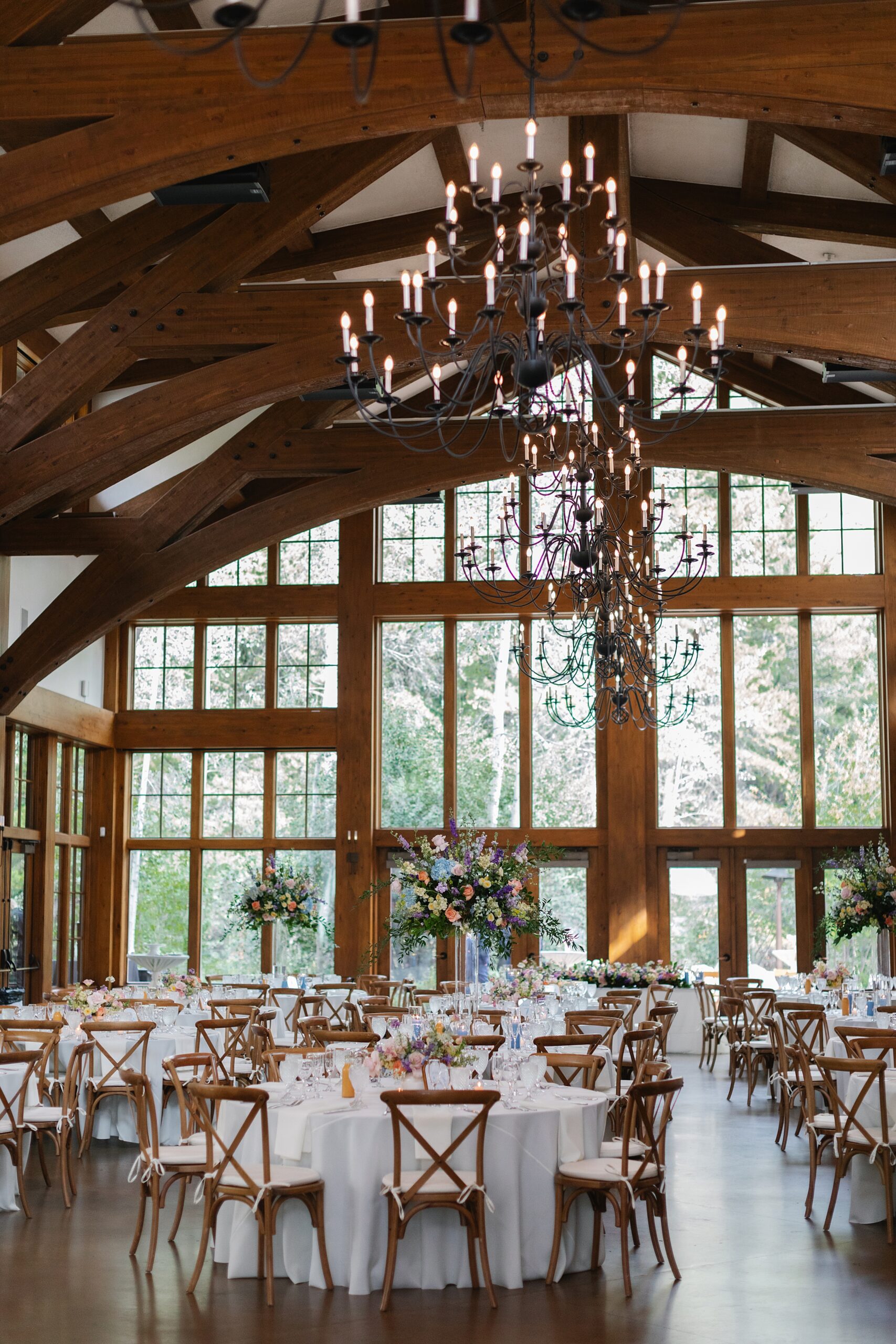 Reception details vail, pastel florals, glass reception venues, floor to ceiling windows wedding venue, chandelier weddings, vail wedding, donovan pavilion reception details
