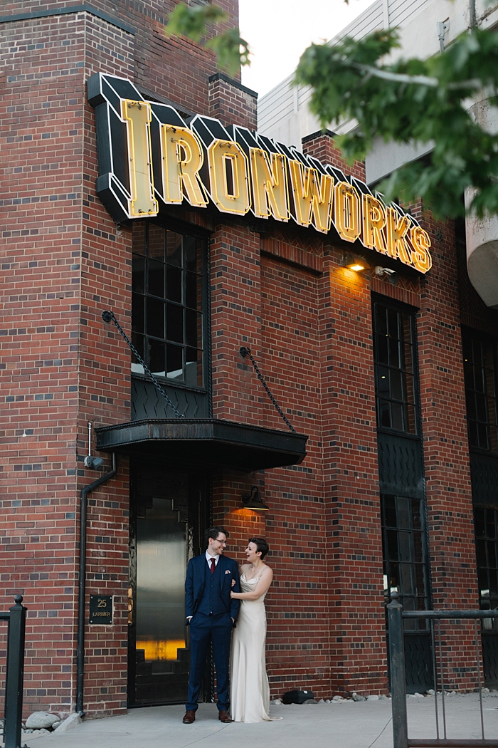Ironworks wedding venue, industrial wedding in Denver, historic wedding venues, Colorado wedding venues, Denver wedding photographer, Colorado wedding photographer, satin wedding dress, simple wedding attire inspiration, candid wedding coverage, summer wedding ironworks, wedding inspiration ironworks, warehouse wedding venues, brick wedding venues